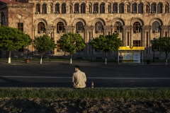 A man sits in a corner alone. He is one of the demonstrators waiting for his friends. Police officers cleared the streets from demonstrators. April 15, 2018, Yerevan-Armenia.