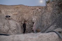 Local people around a well which is used to reach water by many