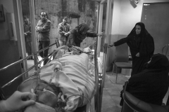 The brain dead person along with his family during the transfer of his body to the operation room for the donating his body parts.A bitter yet beautiful moment of giving life to others.In hospital in Tehran, Jan 2014.