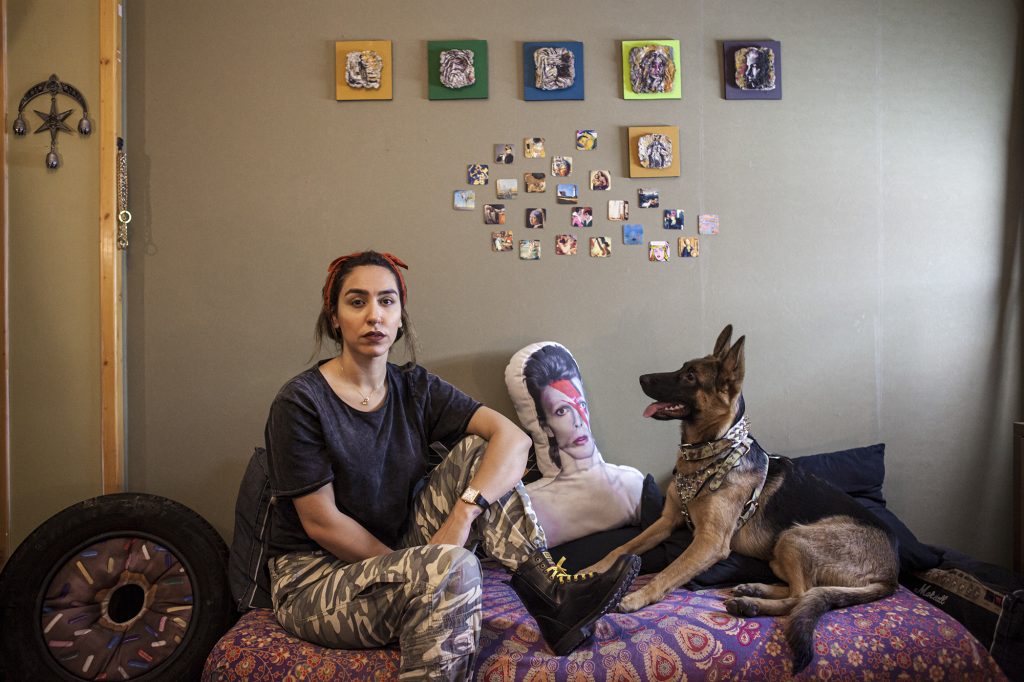 Sarah a 29 year old girl with her dog, Lady. September 2018. Residential place in Tehran.